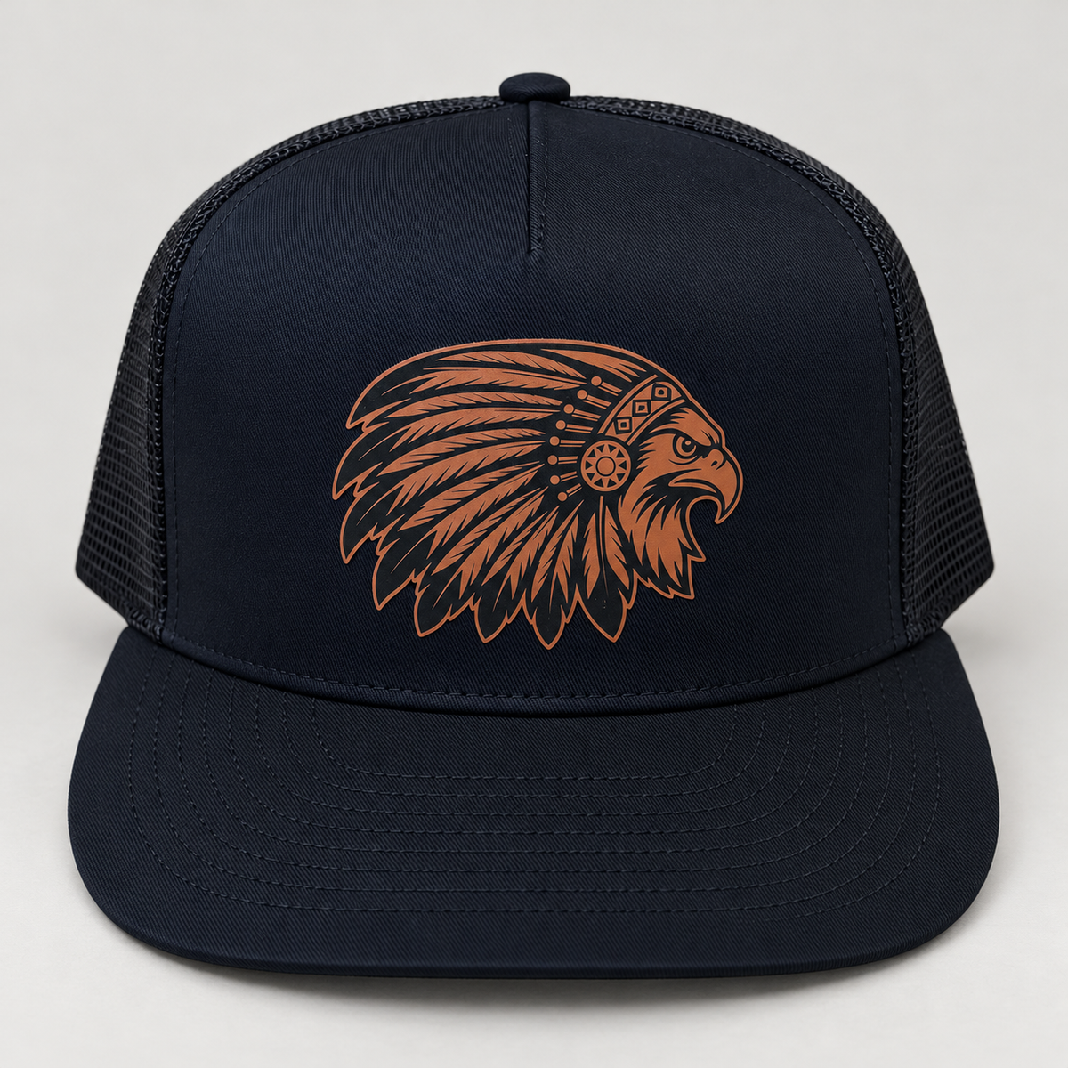 Brown leather feathered hawk patch on a dark trucker hat